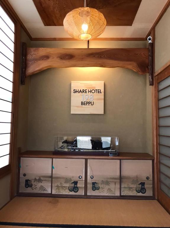 a table in a room with a chandelier at Share Hotel 198 Beppu in Beppu