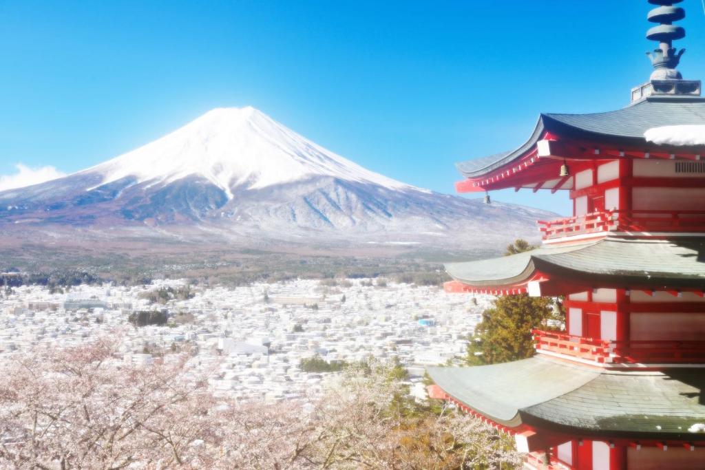 a red pagoda with a mountain in the background at Erable Mt.Fuji "Zen" in Fujikawaguchiko