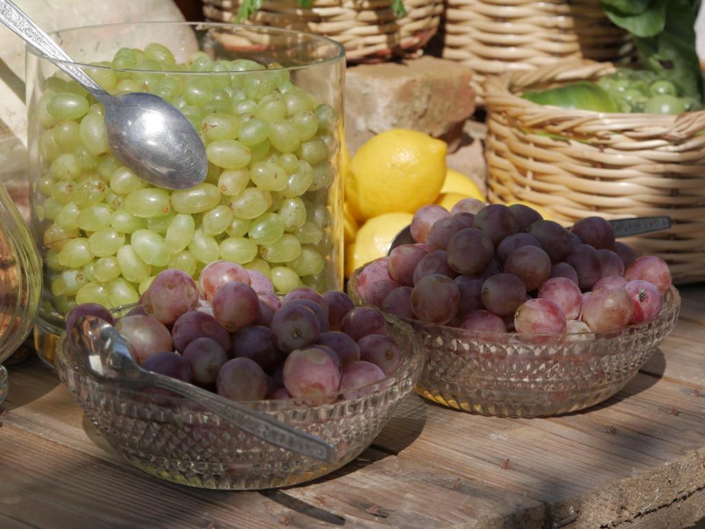 a bunch of grapes and other fruits in baskets at Gastronomy Hotel Kritsa in Portaria