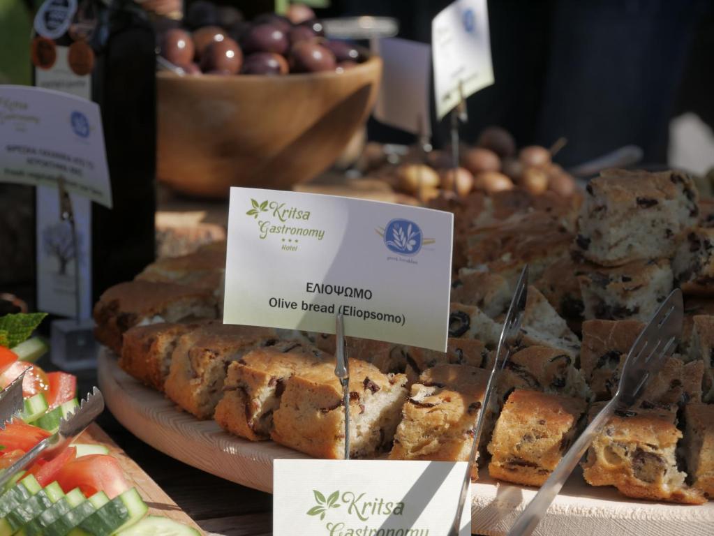 a display of different types of bread on a table at Gastronomy Hotel Kritsa in Portaria