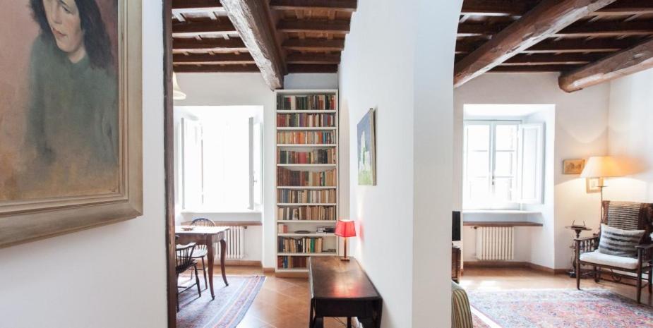 a living room with a book shelf with books at Libri Flat in Rome