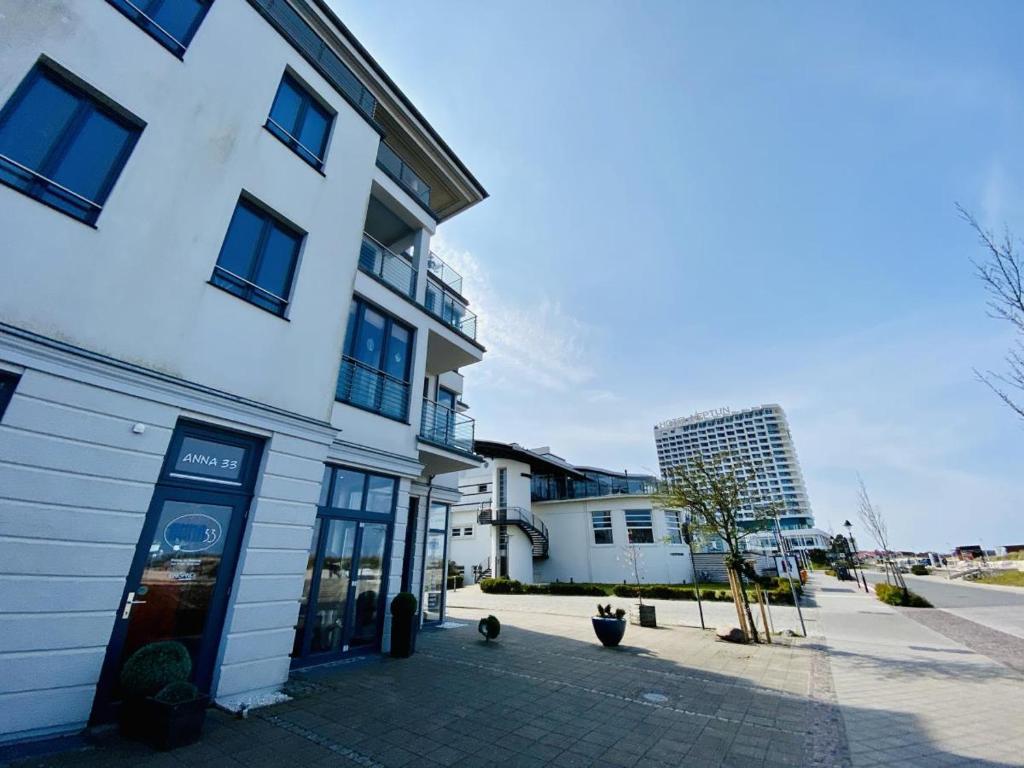 a white building with a store on a street at Marthes Seeblick in Warnemünde