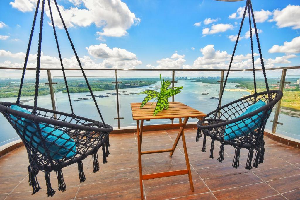 two chairs and a table on a balcony with a view at Country Garden Theme Homestay by Nest Home at Danga Bay in Johor Bahru