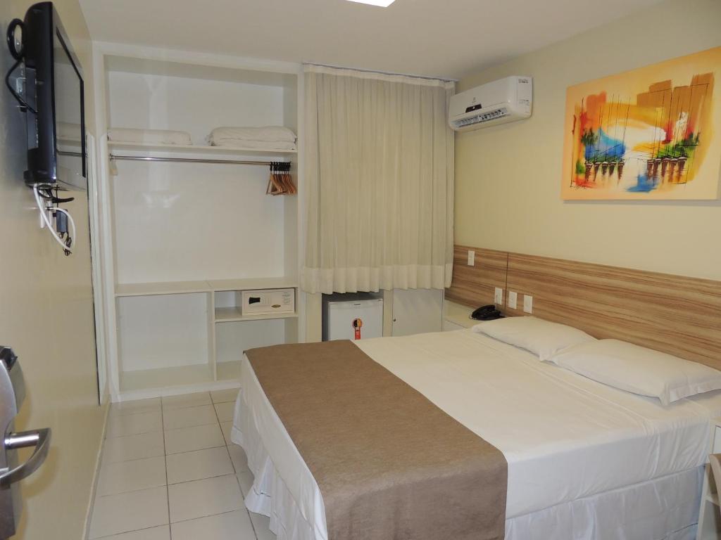 Postel nebo postele na pokoji v ubytování Hotel Três Caravelas
