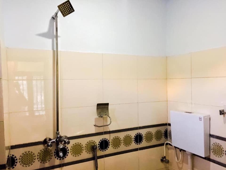a shower stall in a bathroom with aperature at Hotel Lords Palace Kalam in Kārandūkai