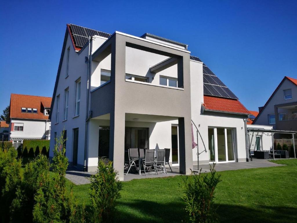 a white house with solar panels on the roof at Ferienhaus Stahl in Muhr amSee