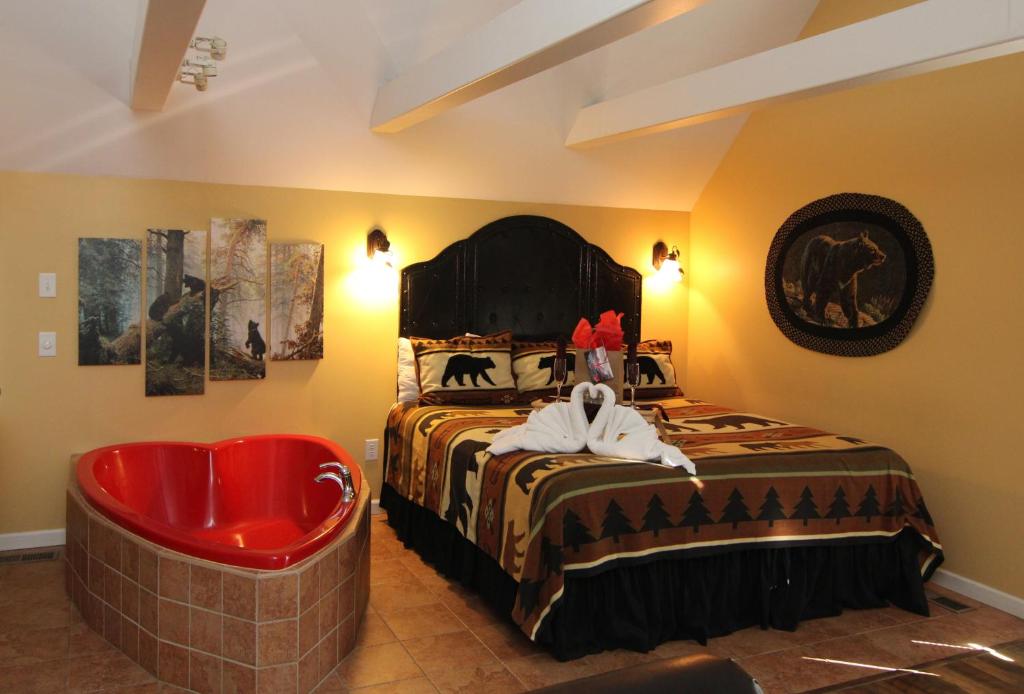 a bedroom with a bed and a red tub at Mountain Romance in Gatlinburg