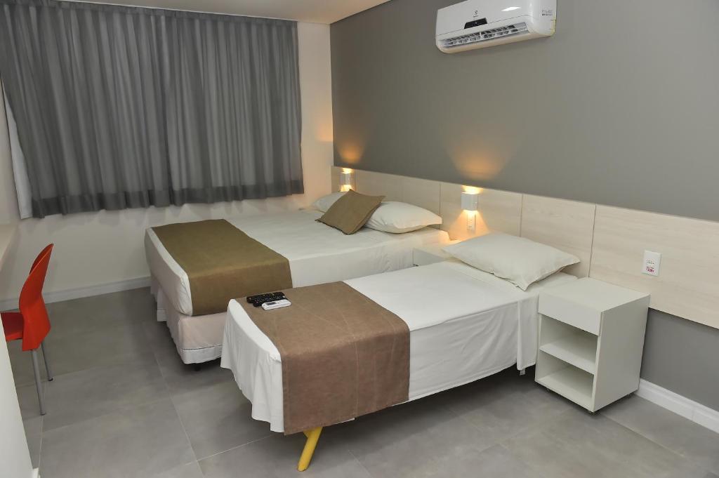 Postel nebo postele na pokoji v ubytování Hotel Três Caravelas