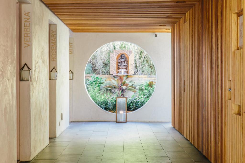a hallway with a circular window in a building at Inn at Moonlight Beach in Encinitas