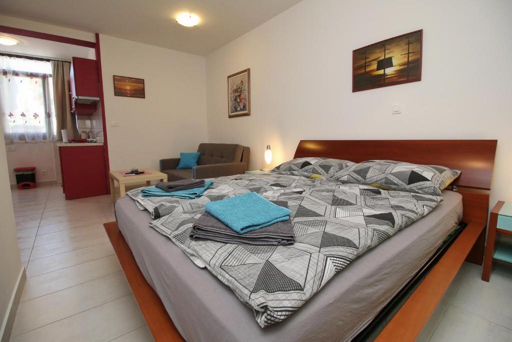 a large bed in a room with a living room at Apartment Svid in Rovinj