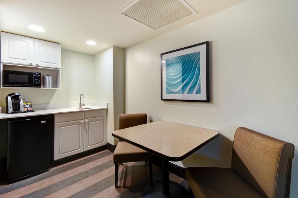 a kitchen and dining room with a table and a counter at Holiday Inn Allentown-Bethlehem by IHG in Allentown