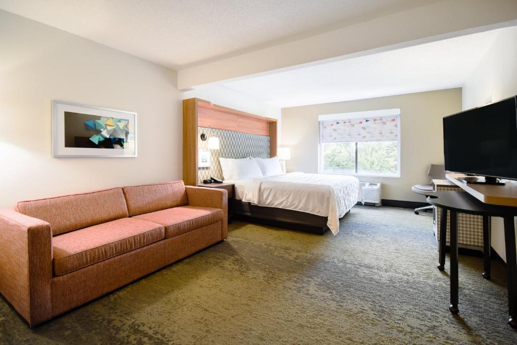 a hotel room with a bed and a couch at Holiday Inn Allentown-Bethlehem by IHG in Allentown