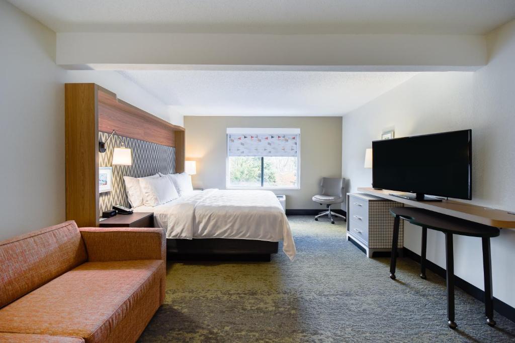 a hotel room with a bed and a flat screen tv at Holiday Inn Allentown-Bethlehem by IHG in Allentown