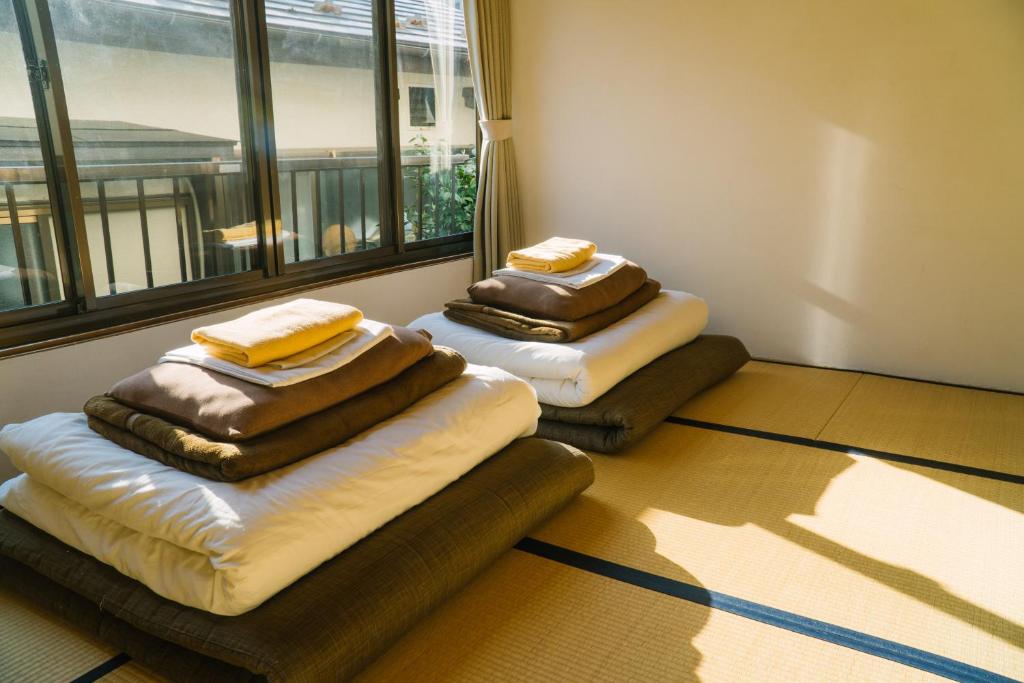 Postel nebo postele na pokoji v ubytování Onsen Guesthouse HAKONE TENT