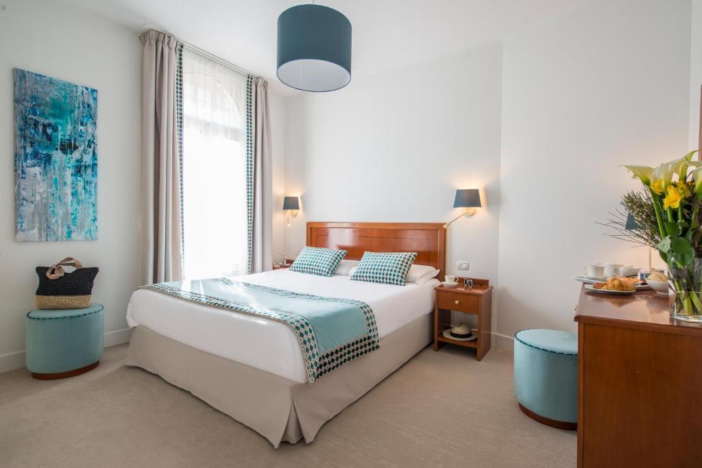 Postel nebo postele na pokoji v ubytování Hotel Olympia