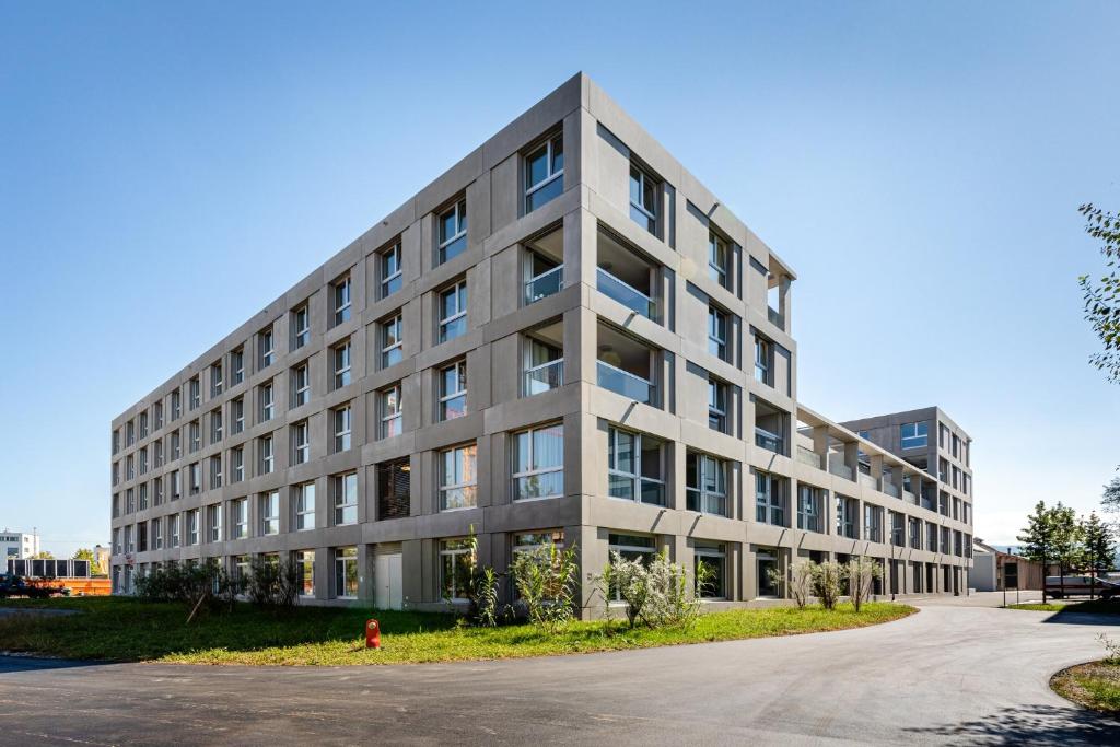 a large gray building with a lot of windows at Giesserei in Arbon