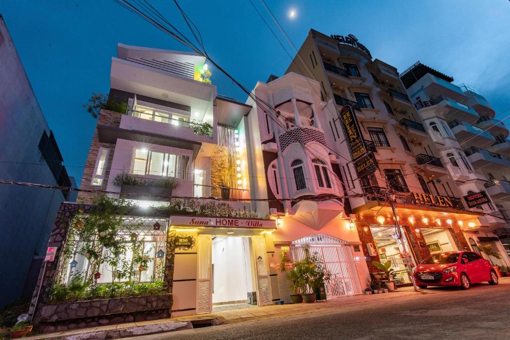 a building with a red car parked in front of it at Suna's HOME - Villa in Vung Tau