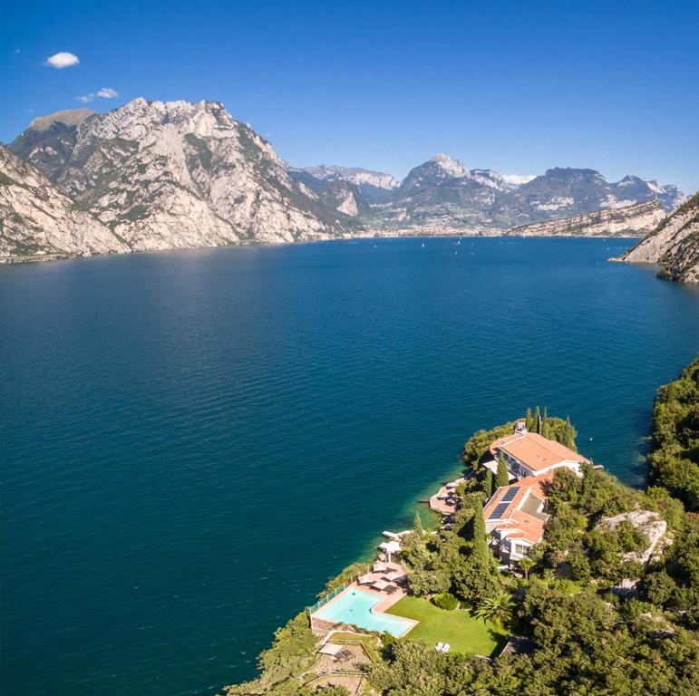 an aerial view of a house on the shore of a lake at Villa Tempesta in Nago-Torbole