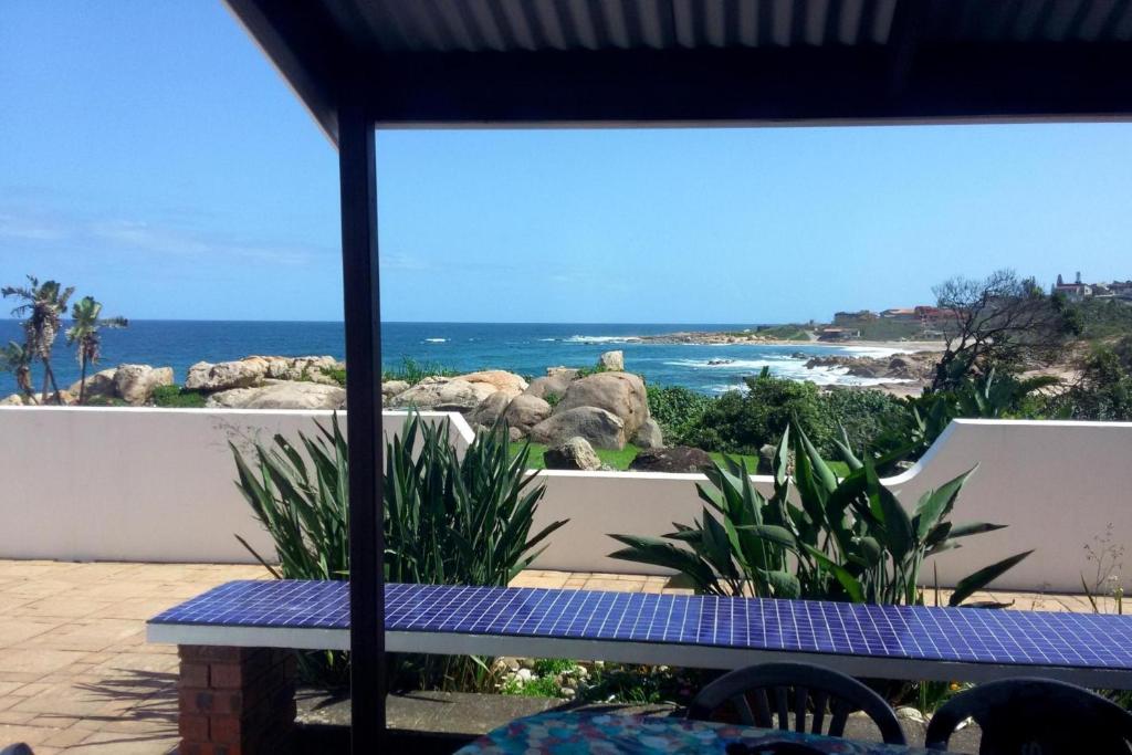 a picnic table on a patio overlooking the ocean at Rosscarbery 6 in Margate