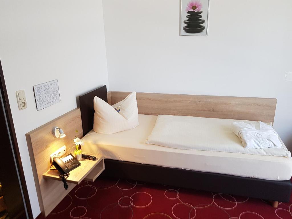 Postel nebo postele na pokoji v ubytování Hotel Promenade