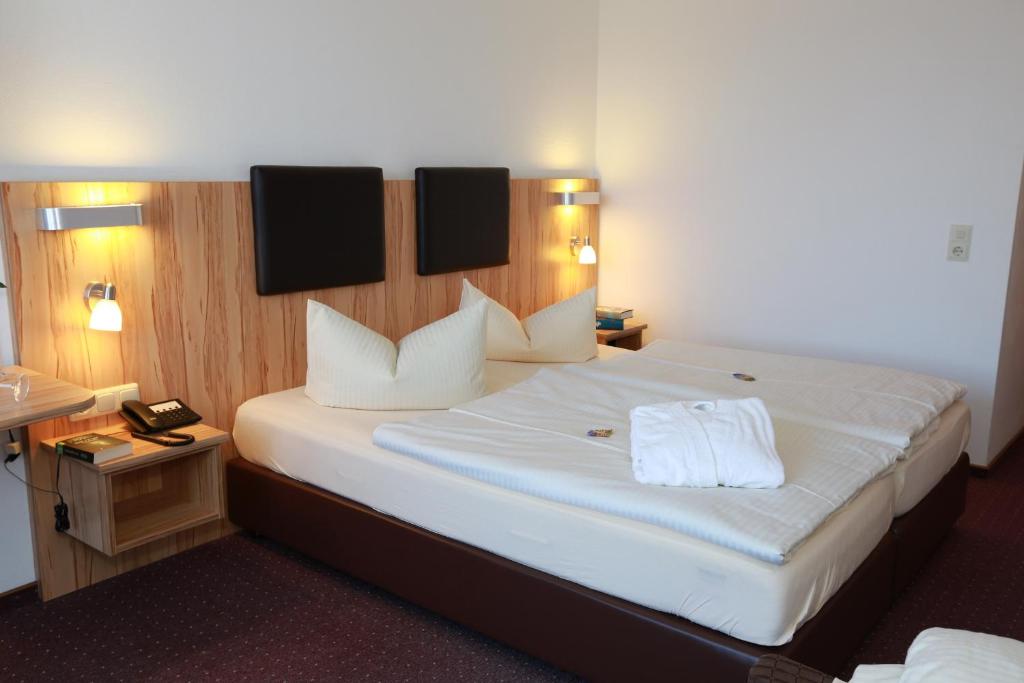 Postel nebo postele na pokoji v ubytování Hotel Promenade