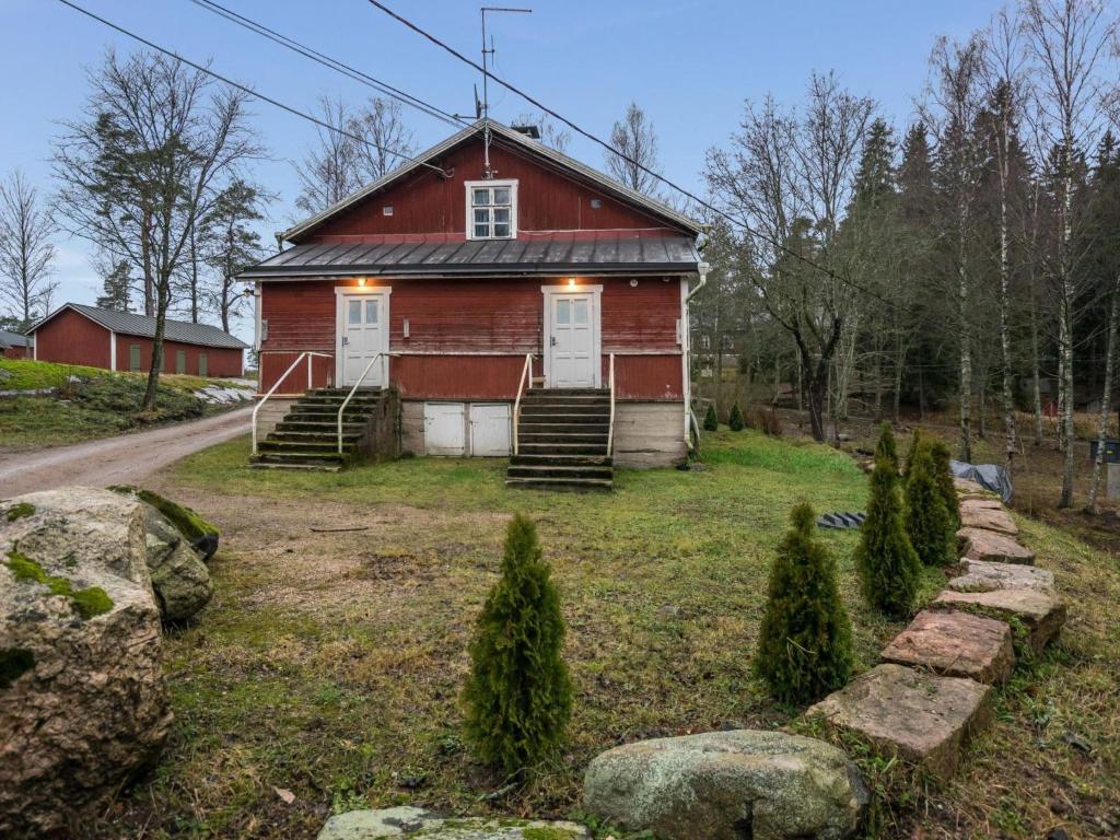 an old red barn with lights on top of it at Holiday Home Nybyggningen by Interhome in Björkboda