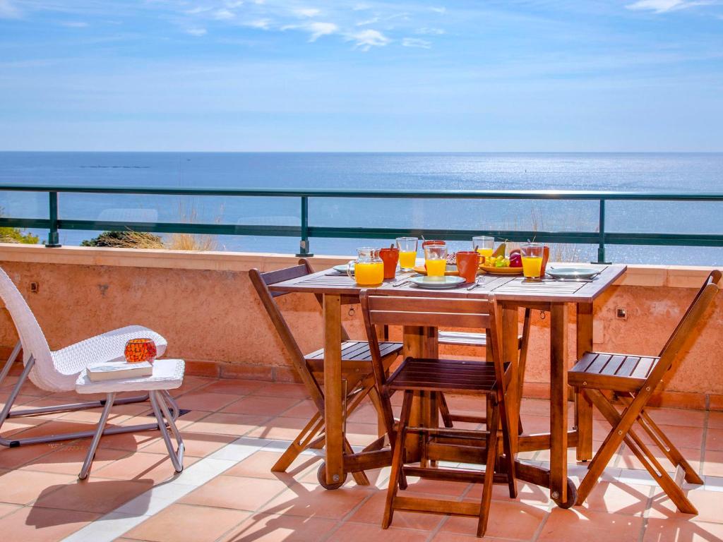 a table and chairs on a balcony with a view of the ocean at Apartment Pueblo Mascarat-2 by Interhome in Altea