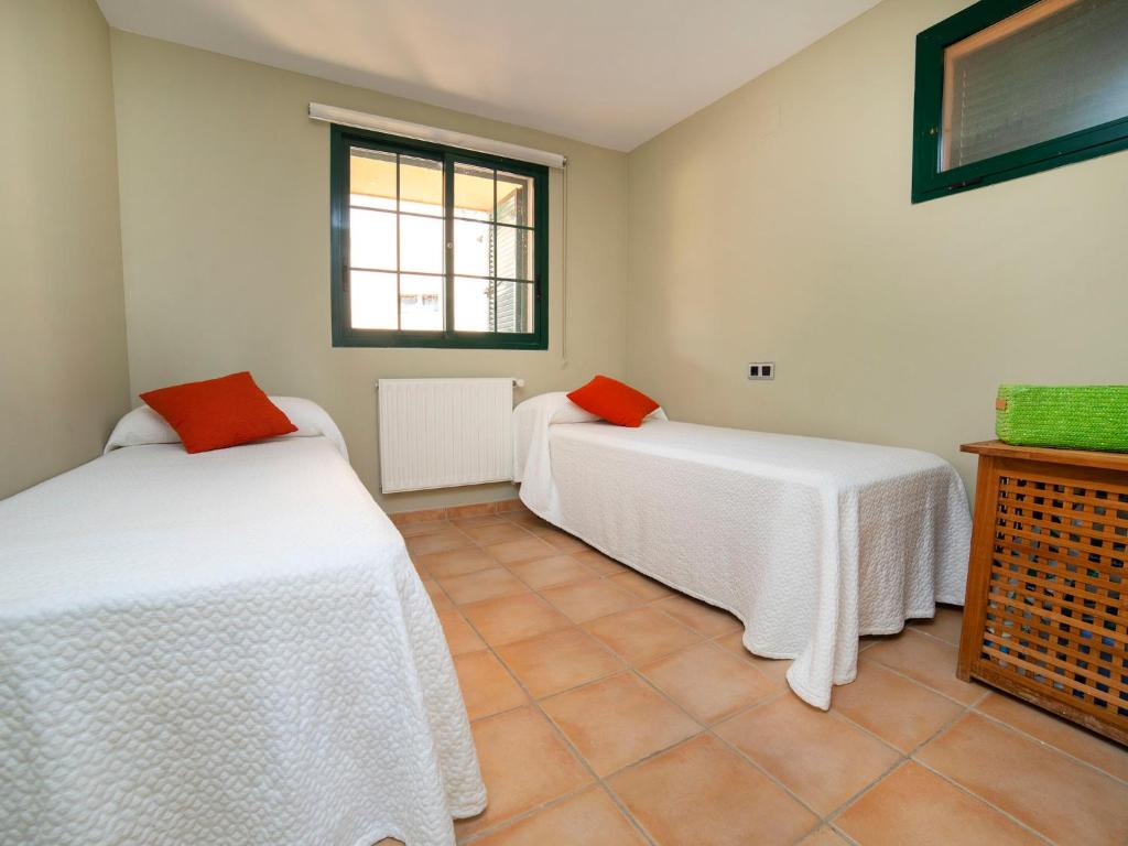 A bed or beds in a room at Apartment Pueblo Mascarat-2 by Interhome