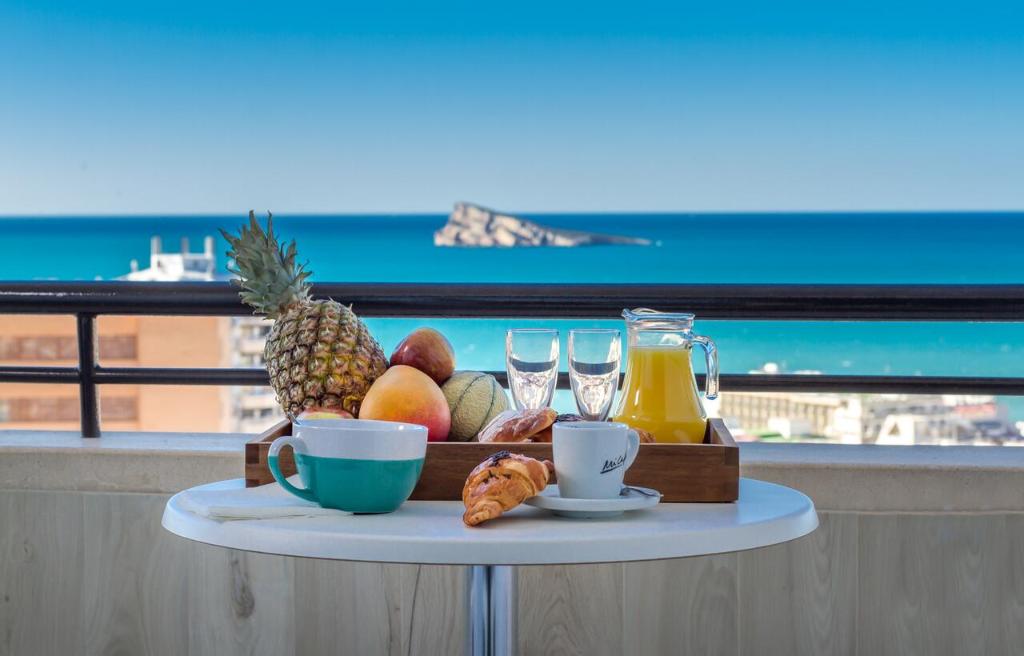 a tray of fruit and drinks on a table on a balcony at Apartamentos La Era Park in Benidorm