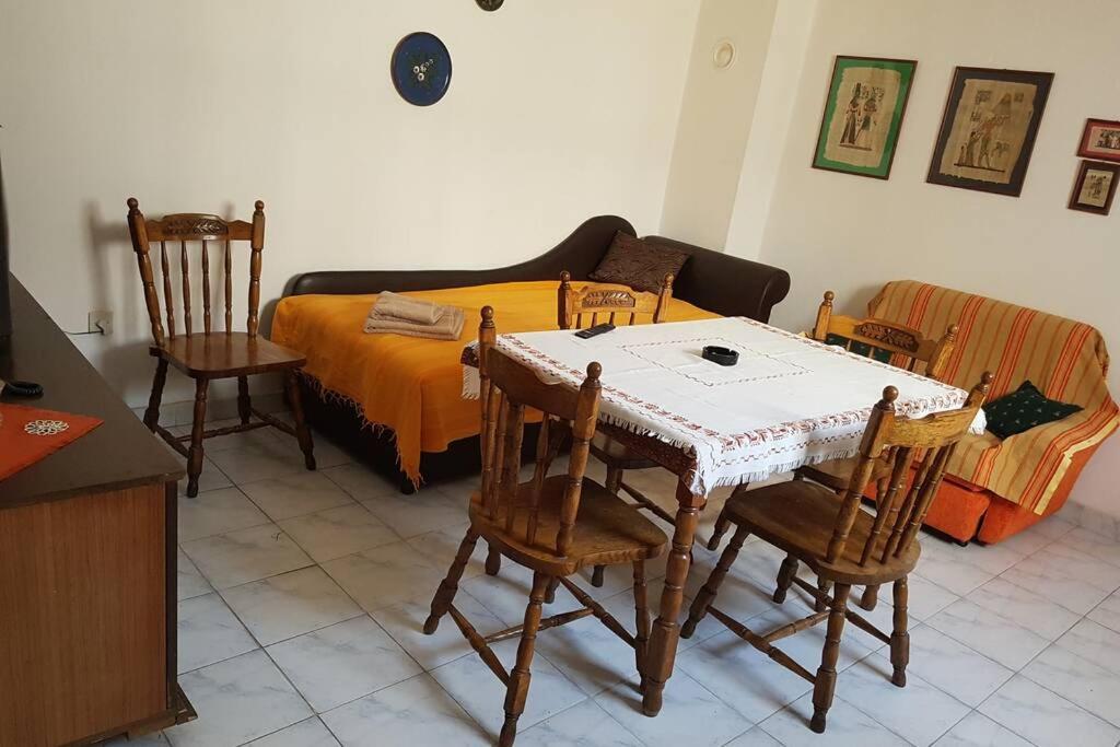 a bedroom with a table and chairs and a bed at A modest place in Belgrade