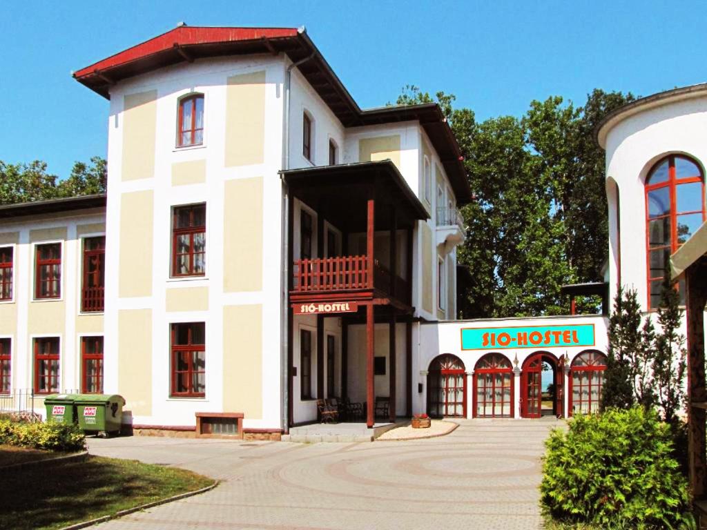 a white building with a no hotel sign in front of it at Sio Hostel in Siófok