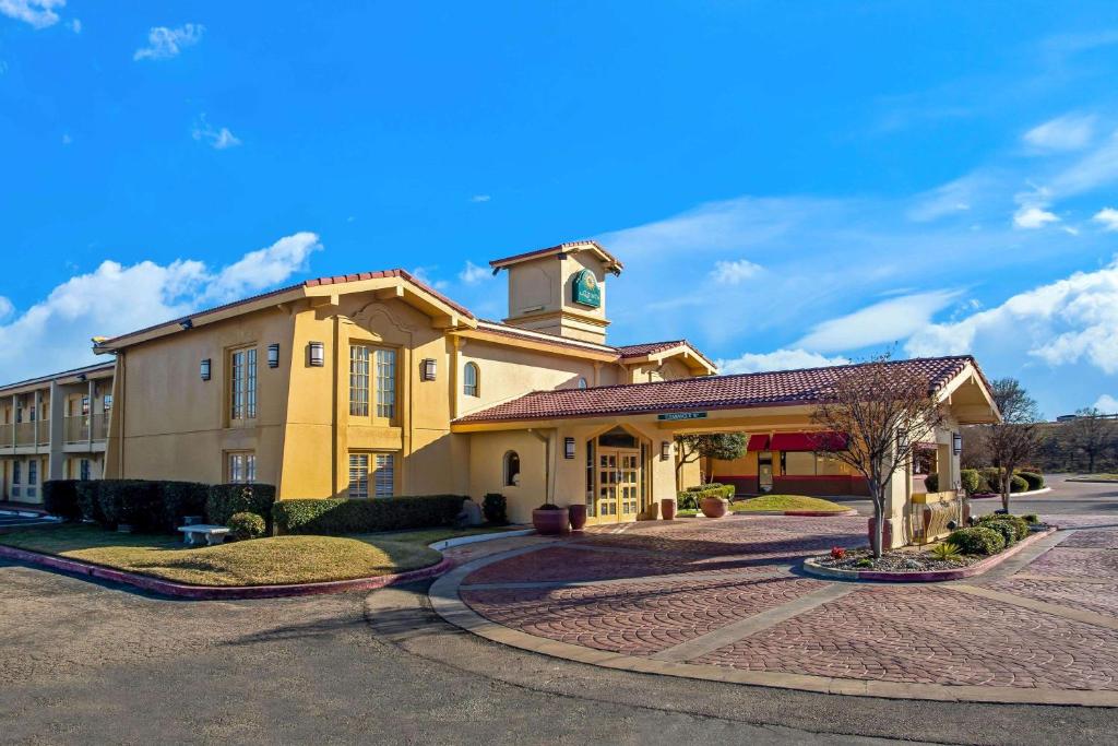 a large yellow building with a clock tower on top at La Quinta Inn by Wyndham Killeen - Fort Hood in Killeen