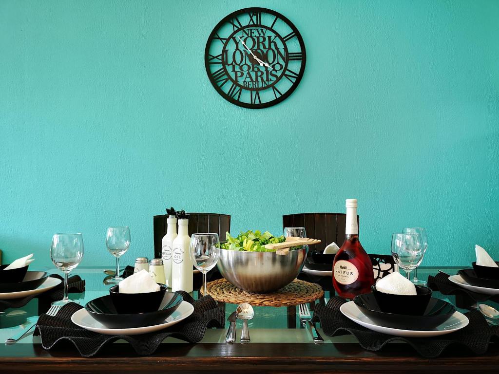 a table with a plate of food and a clock at Tedy's Townhouse-Margarita Gardens in Paphos City