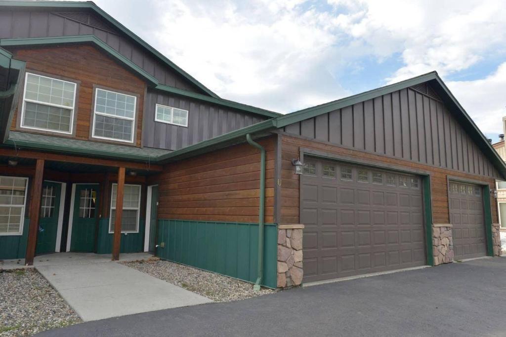 a house with two garage doors and a driveway at Mountain Therapy by Casago McCall - Donerightmanagement in McCall