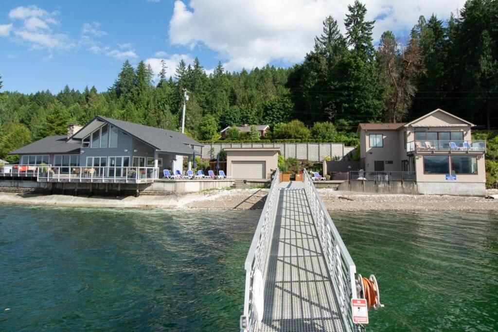 a bridge over the water in front of a house at Hood Canal Resort in Union, WA in Union