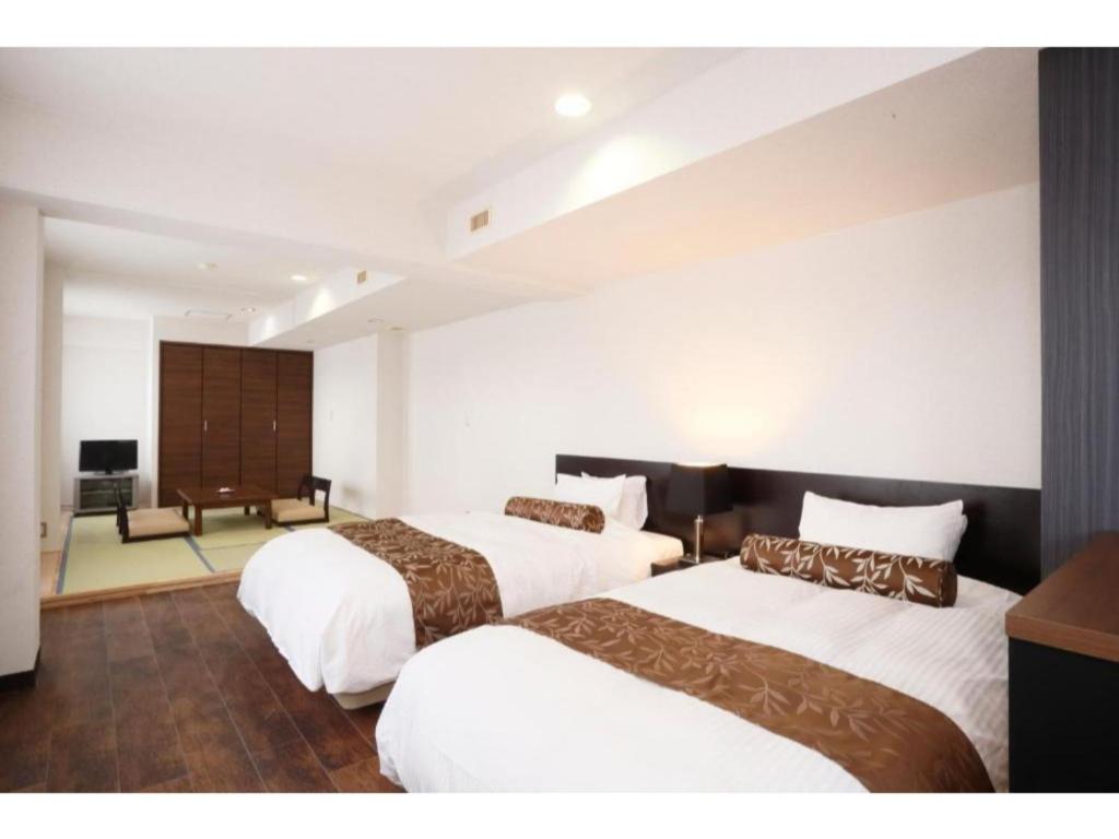Tempat tidur dalam kamar di Tazawako Lake Resort & Onsen / Vacation STAY 78939