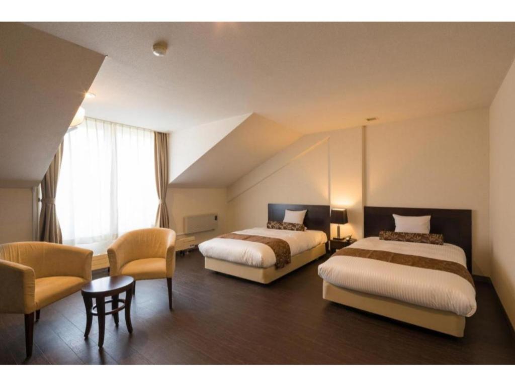 En eller flere senger på et rom på Tazawako Lake Resort & Onsen / Vacation STAY 78988