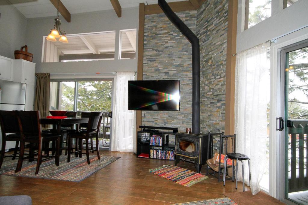 a living room with a table and a fireplace at Sierra Park Villas #03 in Mammoth Lakes