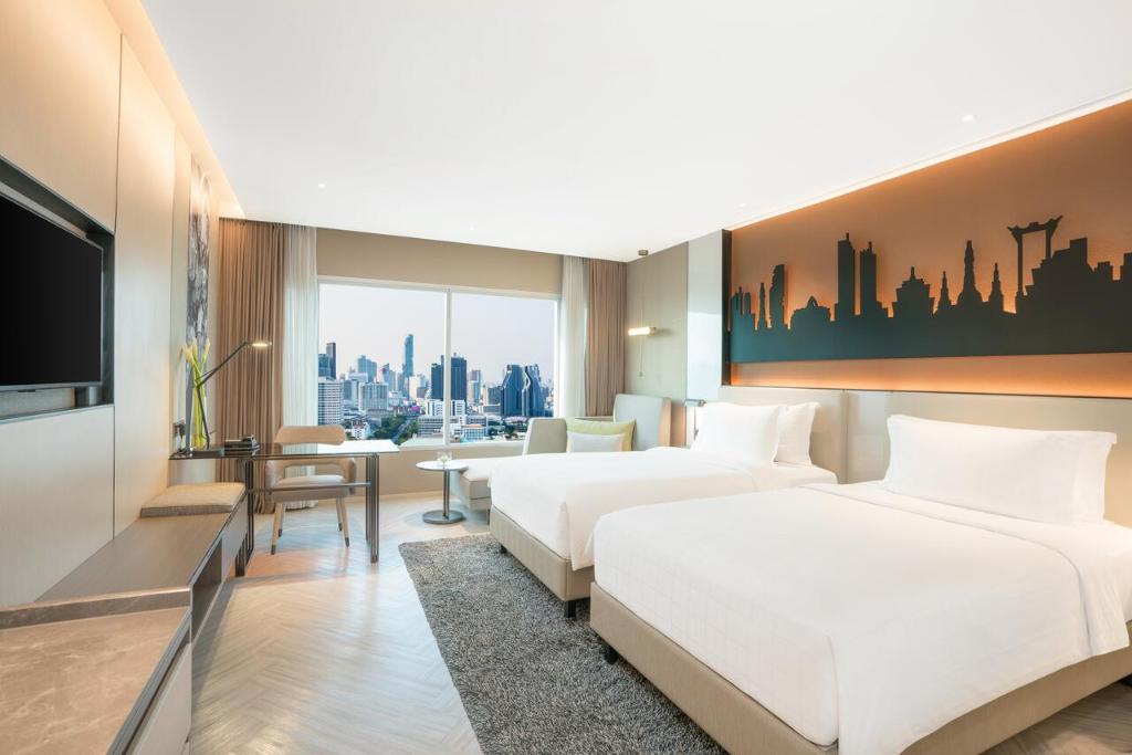 Postel nebo postele na pokoji v ubytování Pathumwan Princess Hotel - SHA Extra Plus Certified