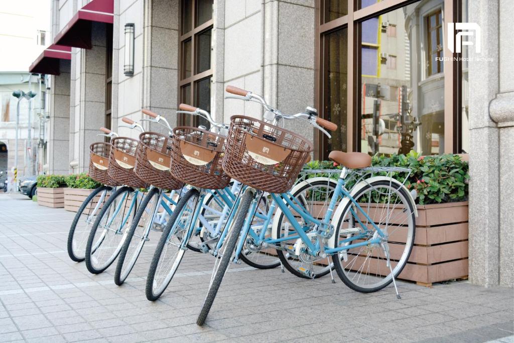a row of bikes parked in front of a building at Fushin Hotel Taichung in Taichung