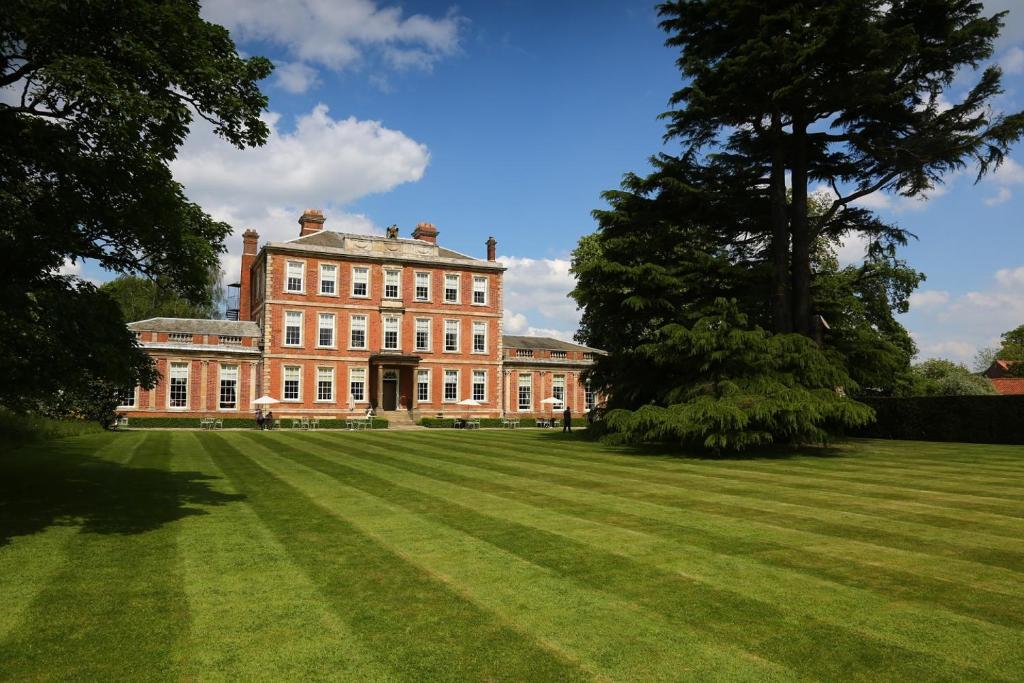 a large brick building with a large grass field at Middlethorpe Hall & Spa in York