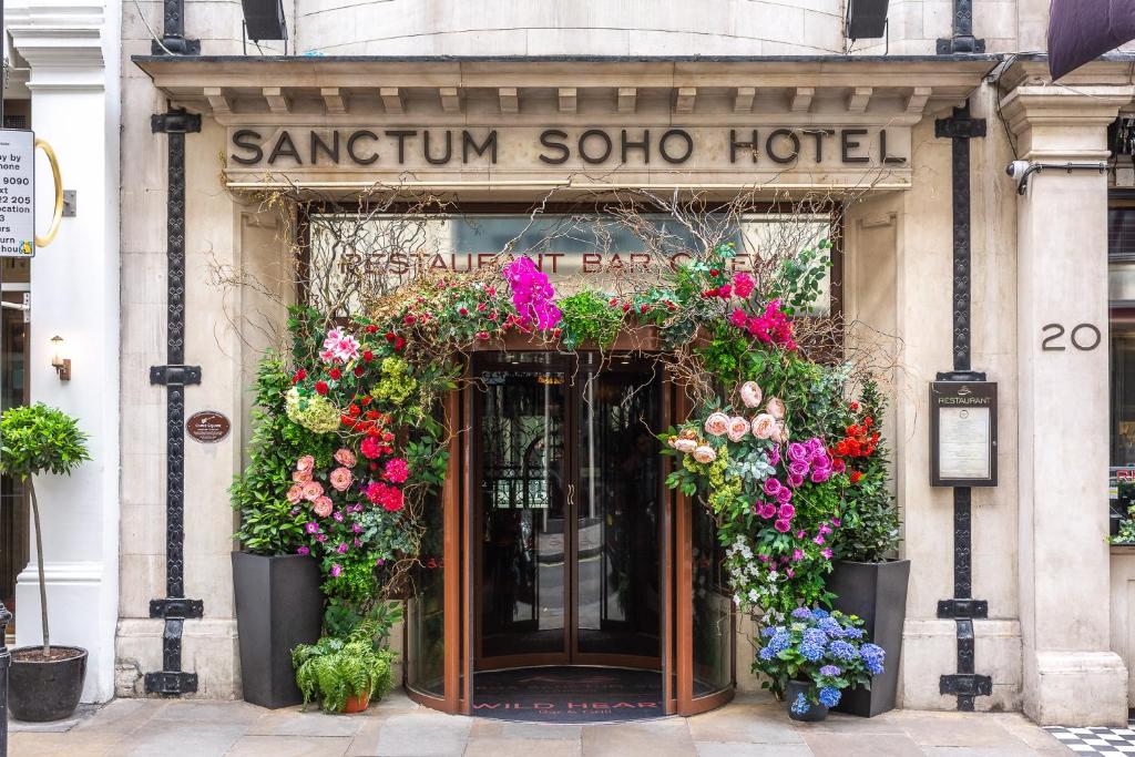an entrance to a sakura soo hotel with flowers at Karma Sanctum Soho Hotel in London