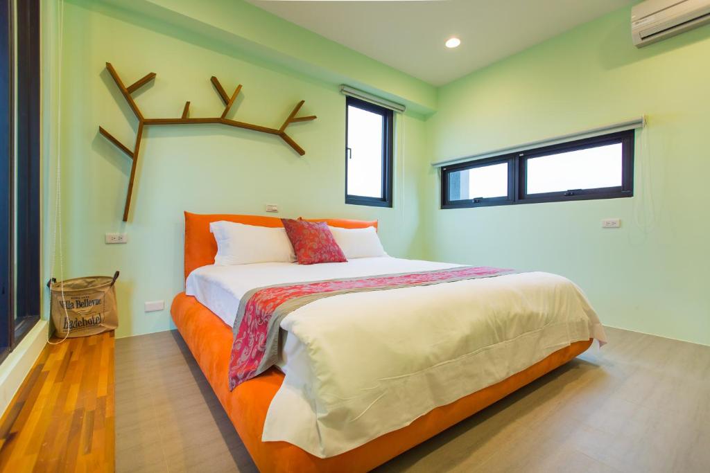 a bedroom with a large bed with antlers on the wall at Lanyang Beach Villa in Wujie
