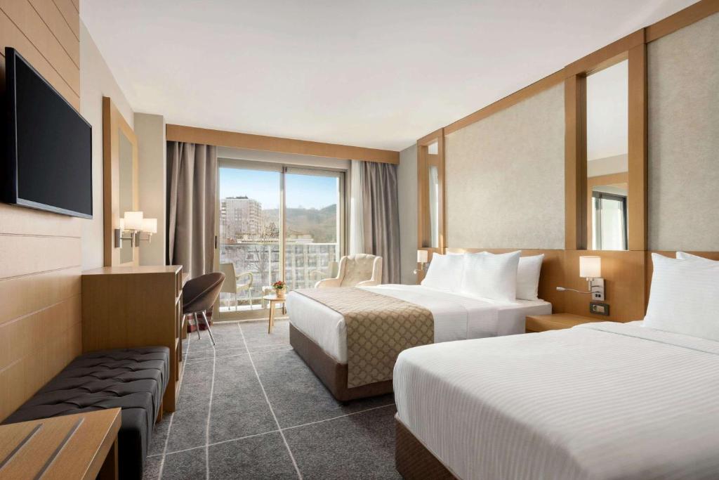 A bed or beds in a room at Ramada Resort by Wyndham Unye