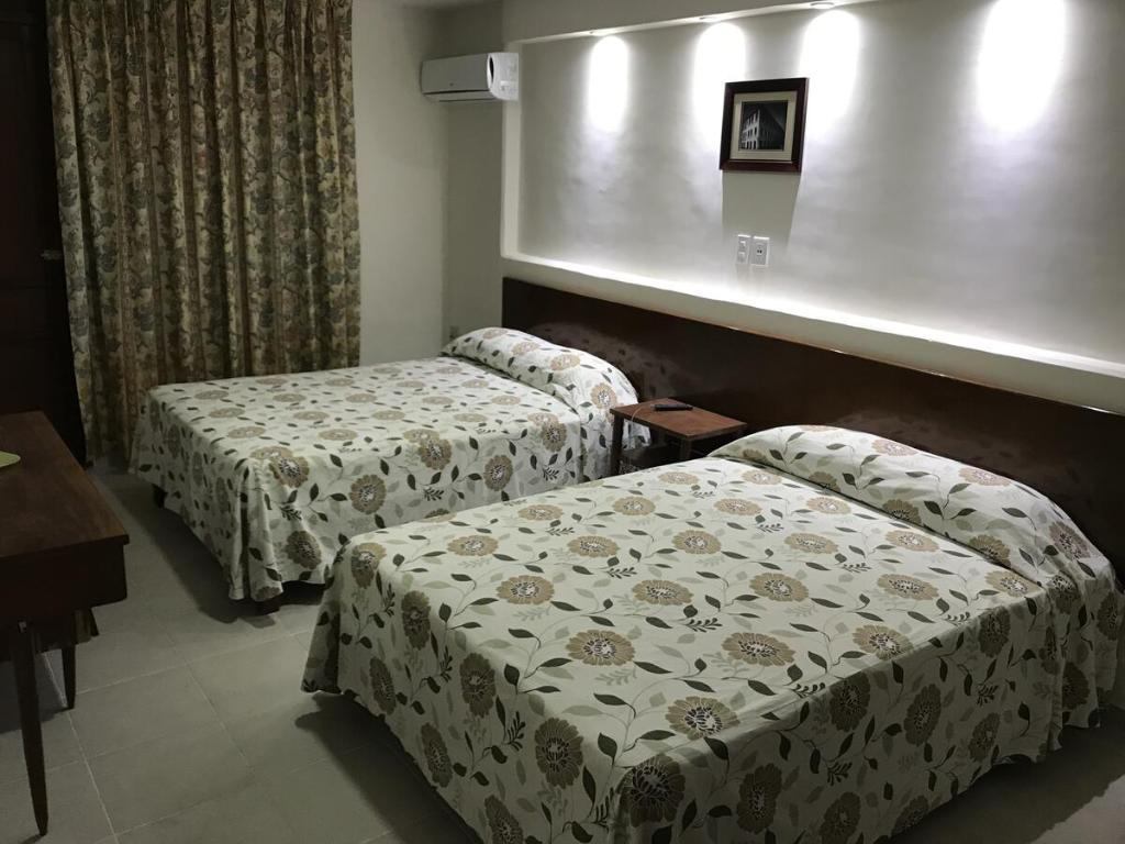 Postel nebo postele na pokoji v ubytování Hotel Oriente
