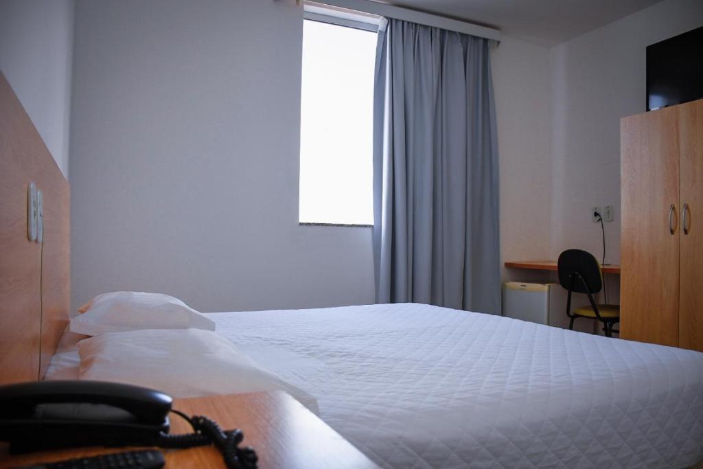 Postel nebo postele na pokoji v ubytování Pioneiro Hotel