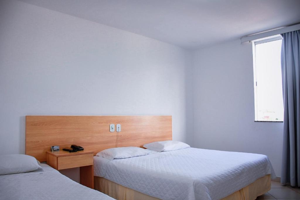Postel nebo postele na pokoji v ubytování Pioneiro Hotel