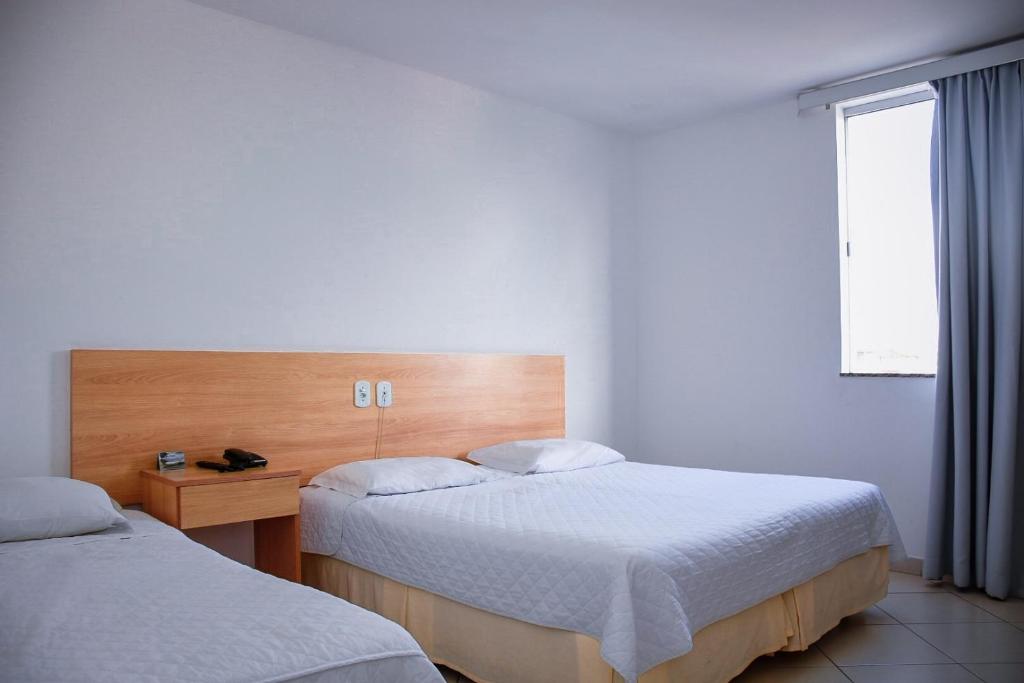 Postel nebo postele na pokoji v ubytování Pioneiro Hotel