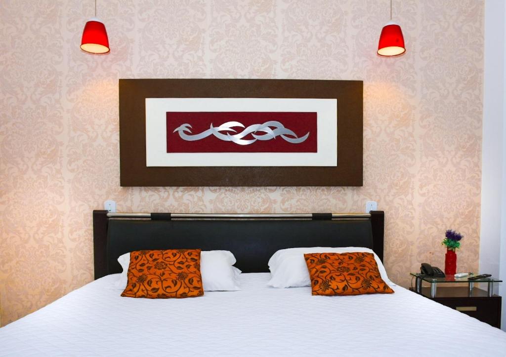 Postel nebo postele na pokoji v ubytování Pioneiro Hotel