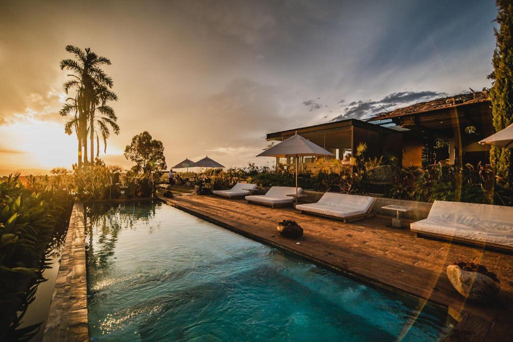 a pool with chaise lounges and a resort at Bio Habitat Hotel in Armenia